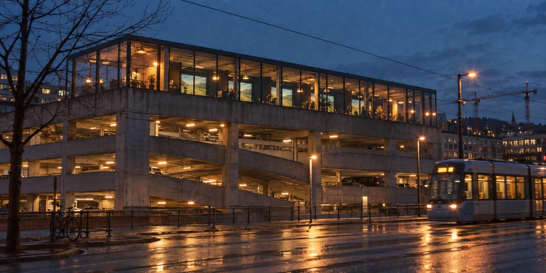 A concrete car park at blue hour with a glazed, lit-up deck on top and a tram passing